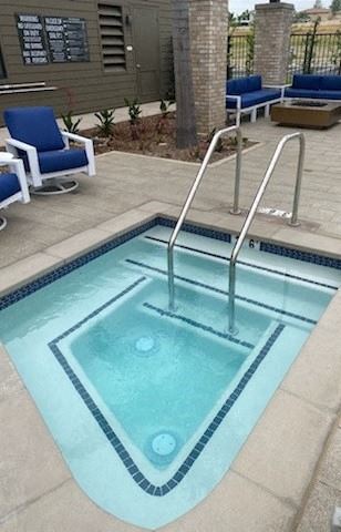 A small swimming pool with a stainless steel hand rail